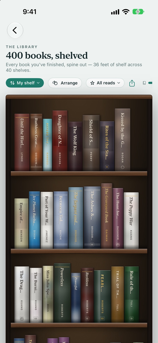 The Library: 400 finished books standing spine-out on walnut shelves
