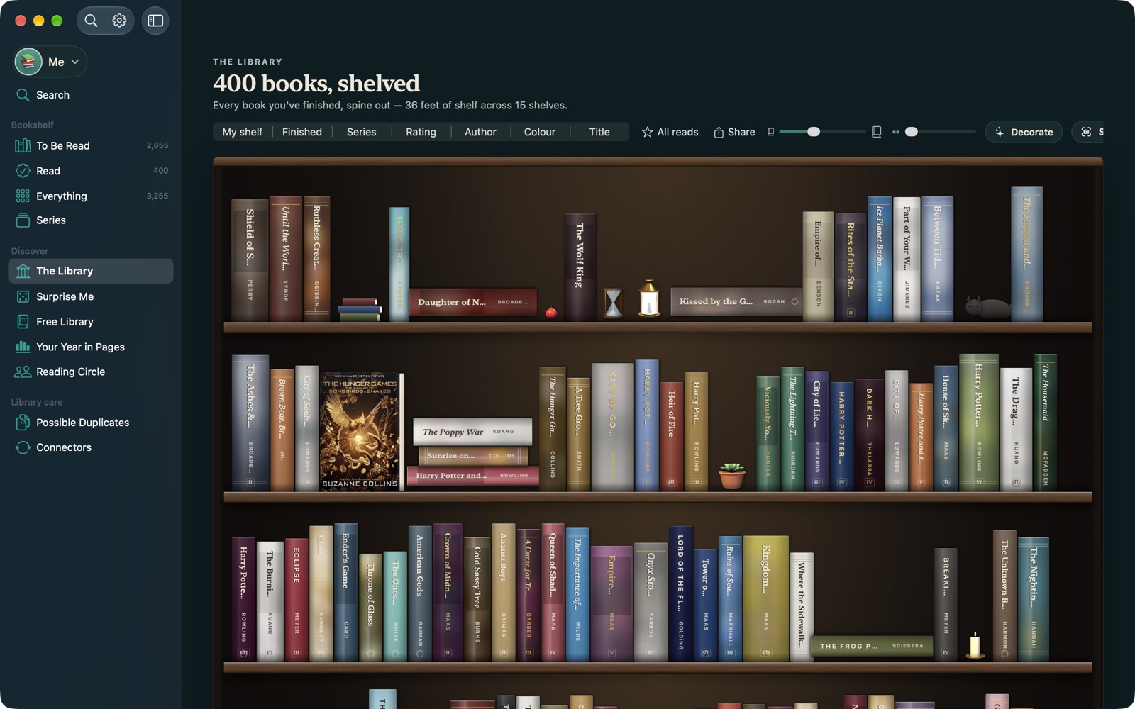 TBR Shelf on Mac: the Library, a wall of finished books spine-out on dark walnut shelves, with the sidebar of shelves on the left